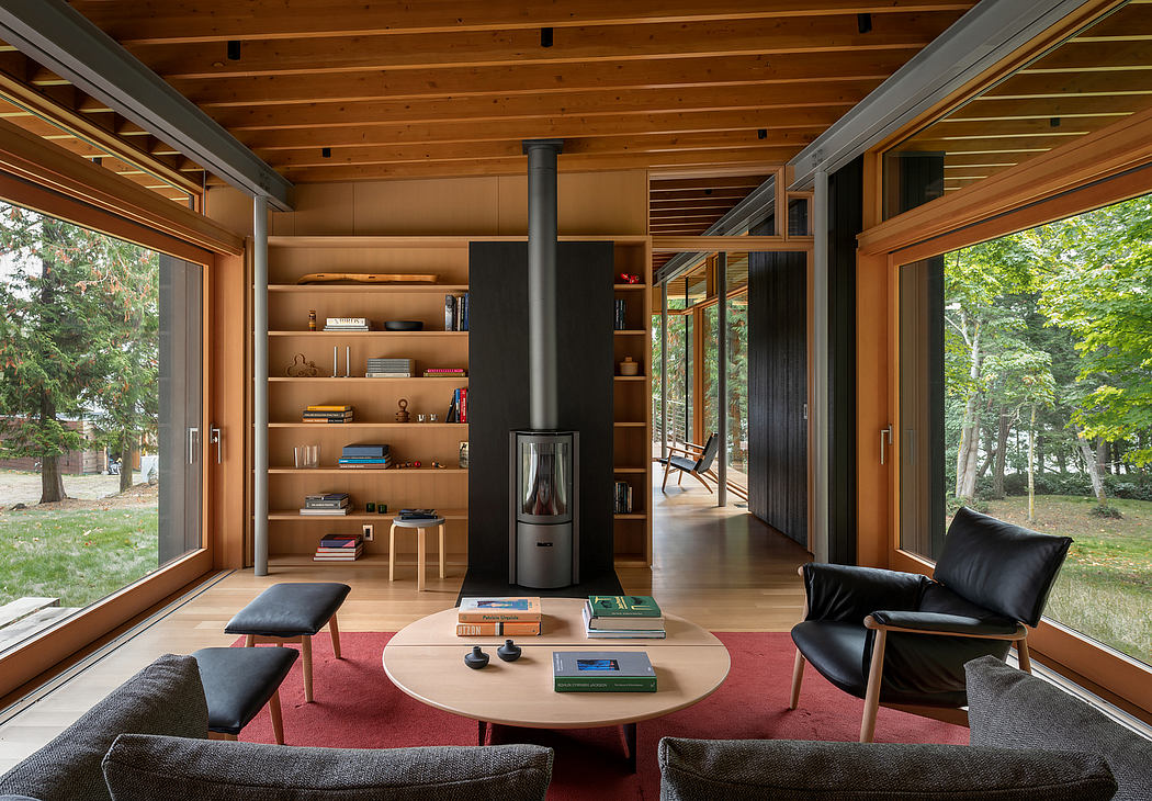 A cozy, modern cabin with an open floor plan, wood-lined ceilings, and floor-to-ceiling windows.