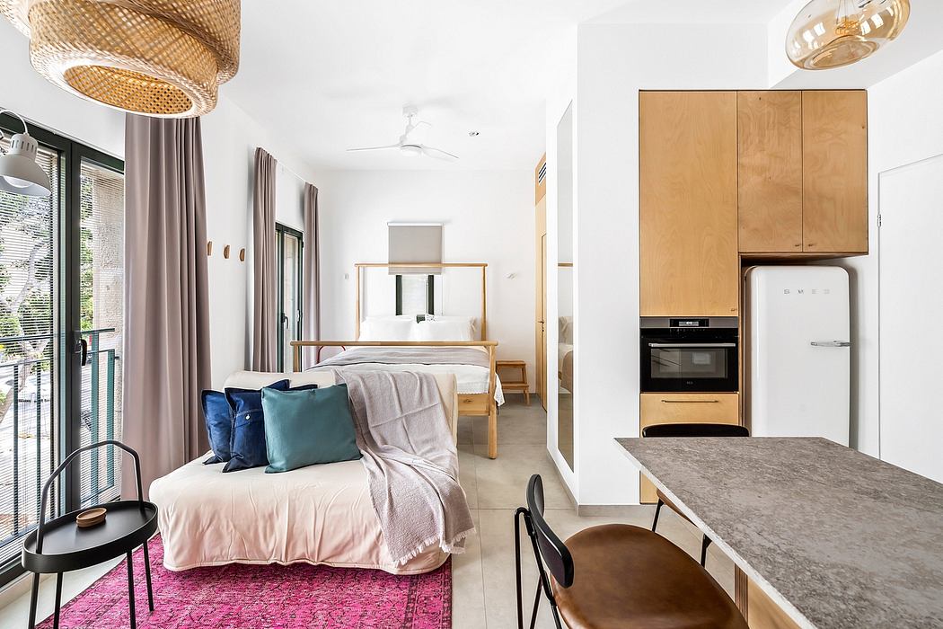 Cozy studio apartment with modern wood accents, plush bedding, and statement lighting.