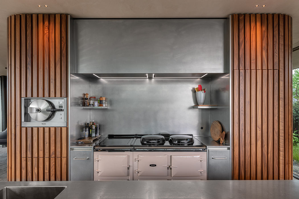 Modern kitchen with sleek stainless steel appliances, wooden accents, and open shelving.