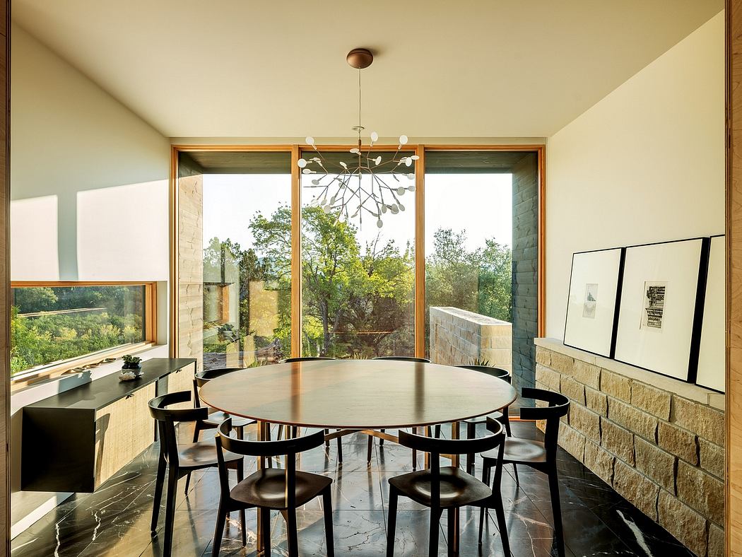 Spacious dining area with sleek modern furnishings and panoramic views through large windows.