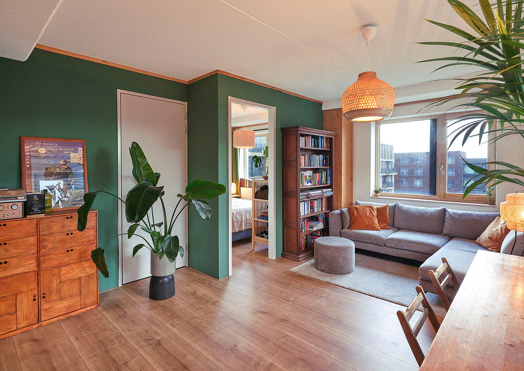 Cozy living room with lush greenery, warm wooden accents, and a modern lighting fixture.