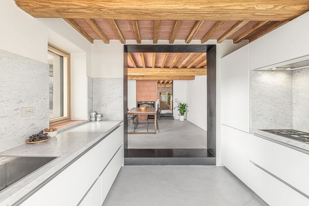 Sleek, modern kitchen with exposed wood beams, marble countertops, and minimalist design.