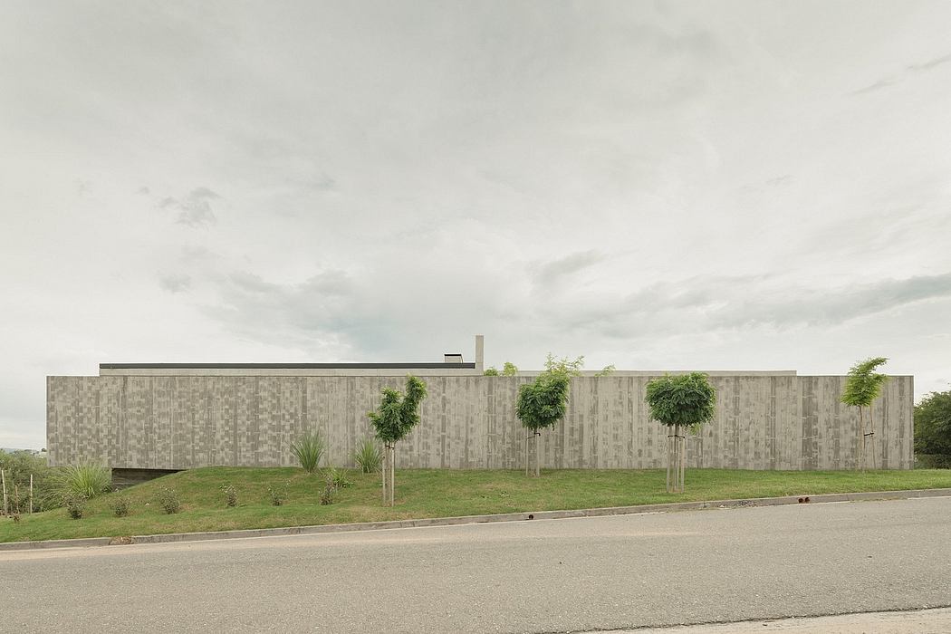 A large, modern concrete building with a prominent facade and landscaped grounds.