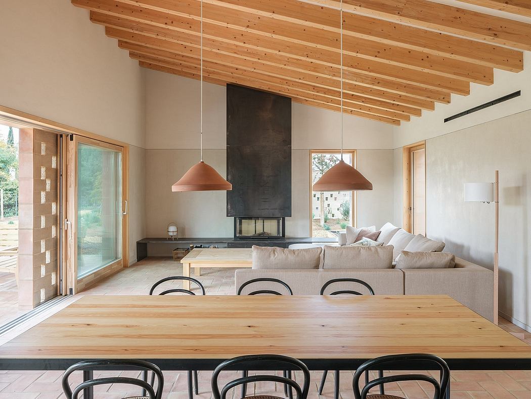 Modern, open-plan living space with high ceilings, wooden beams, and cozy furnishings.