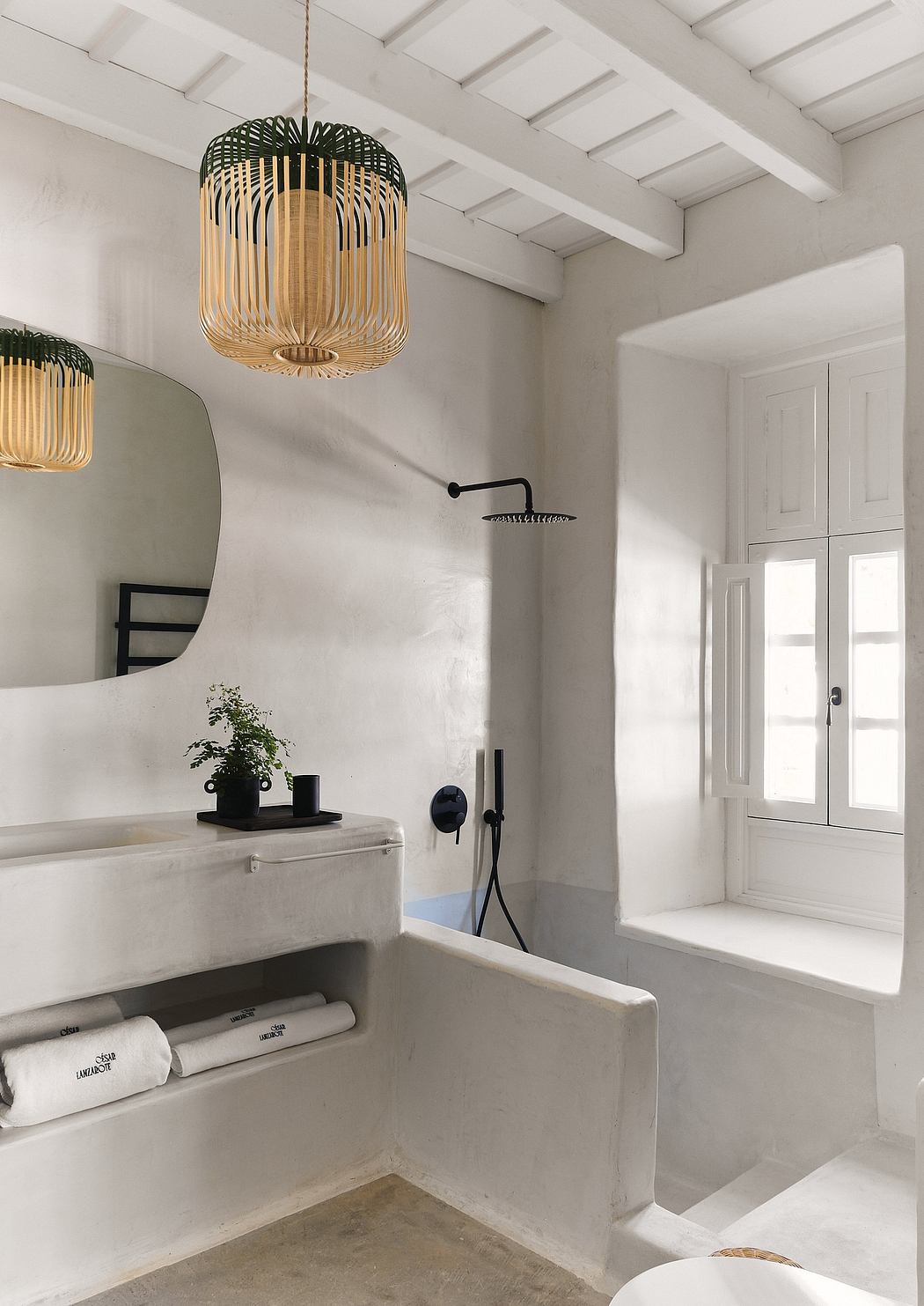 Elegant bathroom with woven pendant lights, white walls, and a modern vanity.