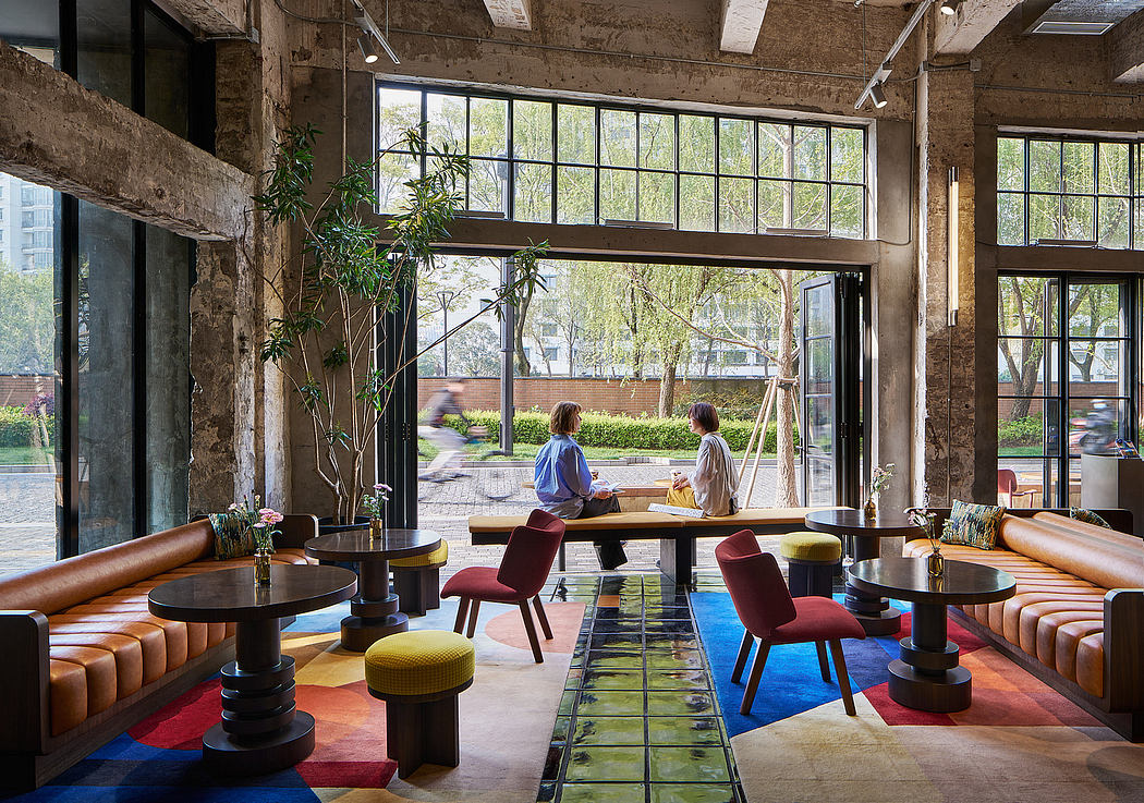 Vibrant industrial-style lounge with eclectic furnishings, large windows, and lush greenery.