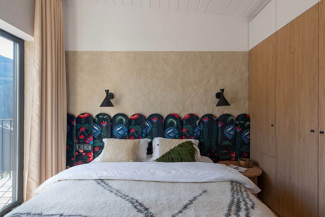 Cozy bedroom with rustic wood paneling, patterned headboard, and modern sconce lighting.