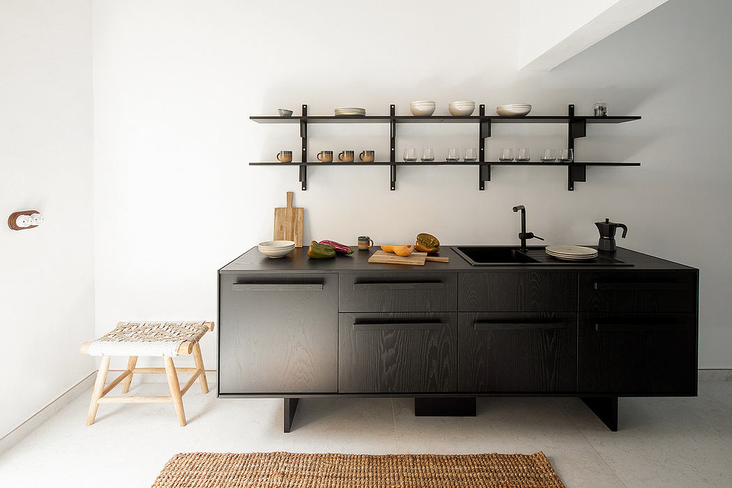 Modern kitchen with sleek black cabinets, open shelving, and minimalist decor.
