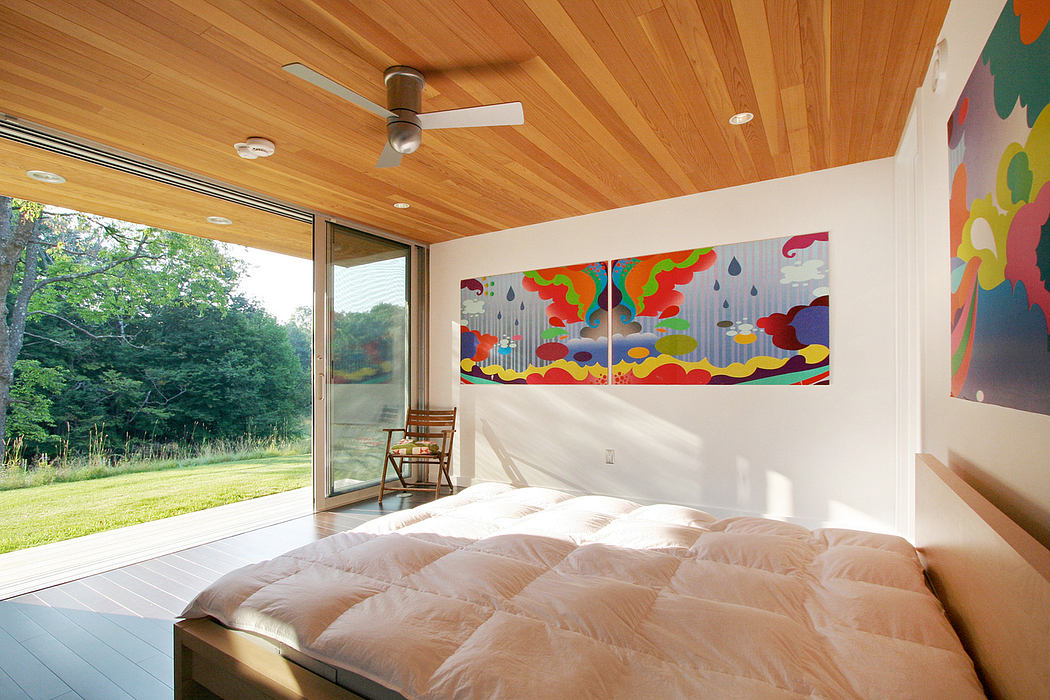 Vibrant, modern interior with floor-to-ceiling windows, wooden ceiling, and colorful artwork.