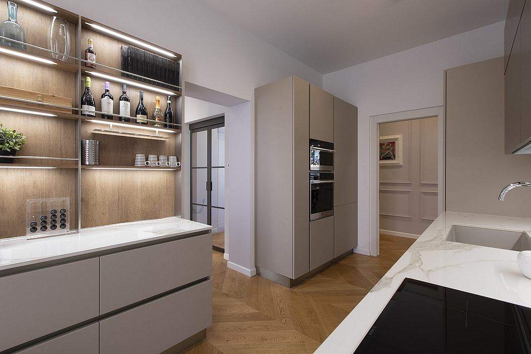 A modern kitchen with sleek cabinets, marble countertops, and built-in appliances.