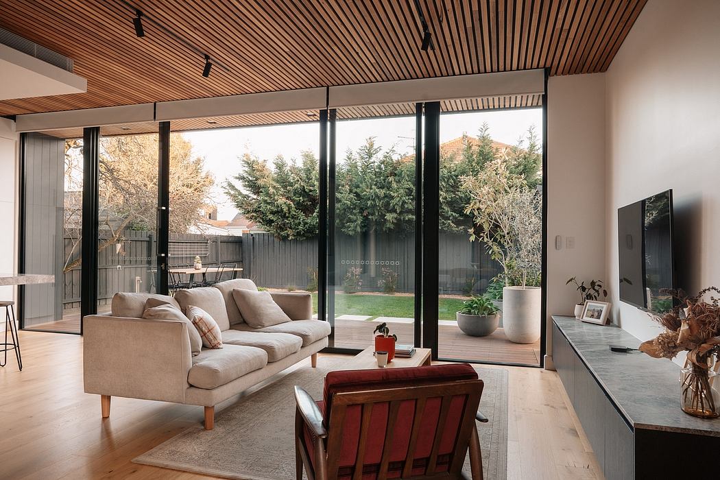 Expansive glass walls provide ample natural light in this modern, wood-paneled interior.