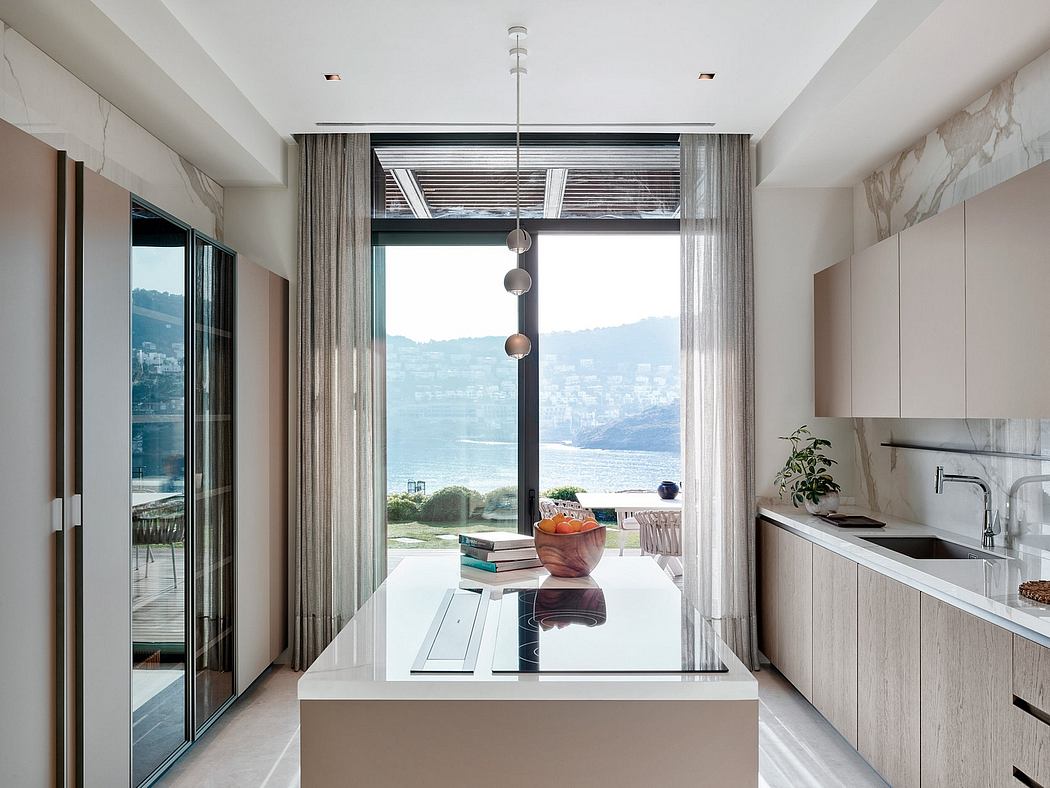 Sleek modern kitchen with floor-to-ceiling windows overlooking scenic lake and mountains.