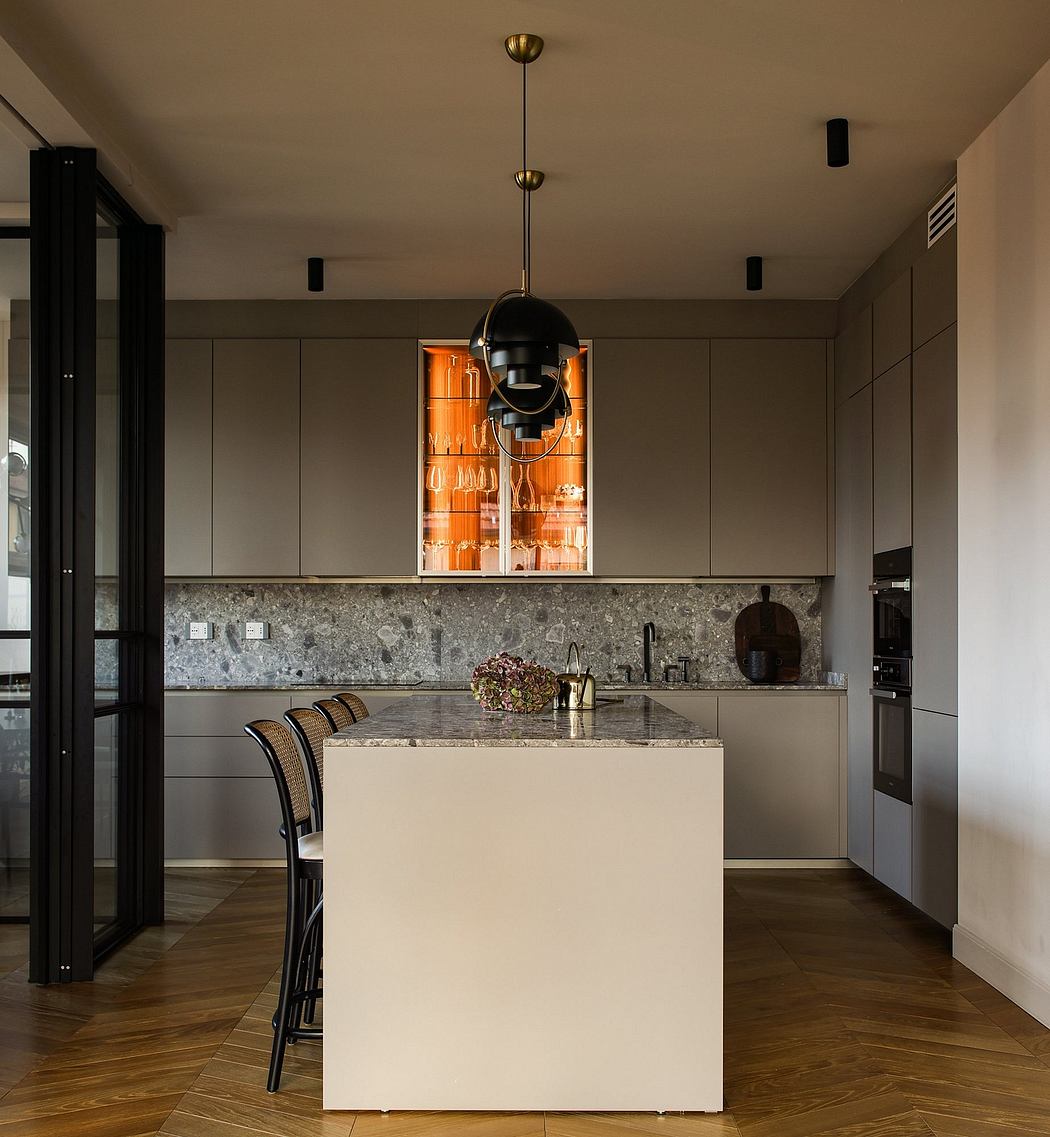Minimalist kitchen with sleek gray cabinets, stone backsplash, and pendant lighting.