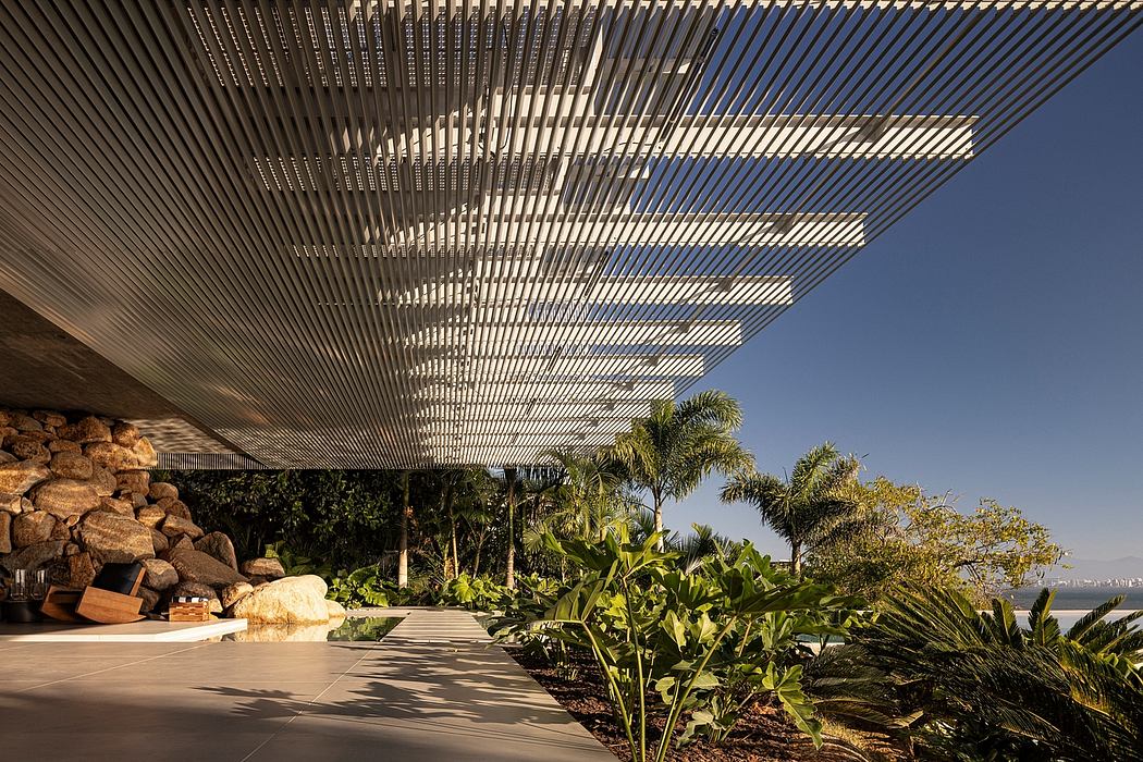 A striking architectural canopy casts intricate shadows over a lush tropical garden.