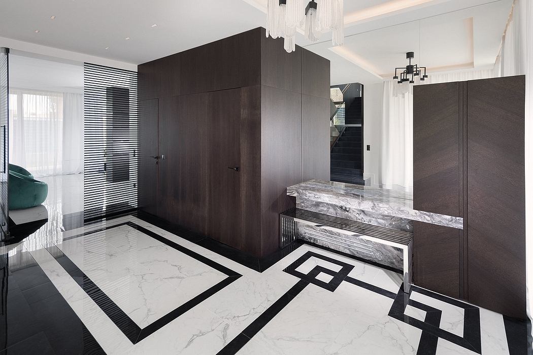 Striking black and white marble floor pattern, modern built-in cabinetry, and sleek chandelier.