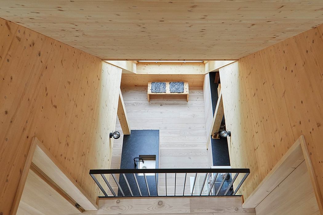 Rustic wooden interior with loft, stairs, and modern furniture details.