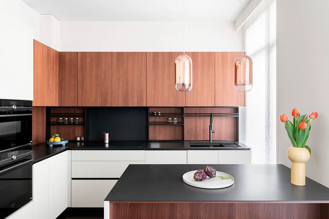 A modern kitchen with clean lines, dark wood cabinets, and copper pendant lights.