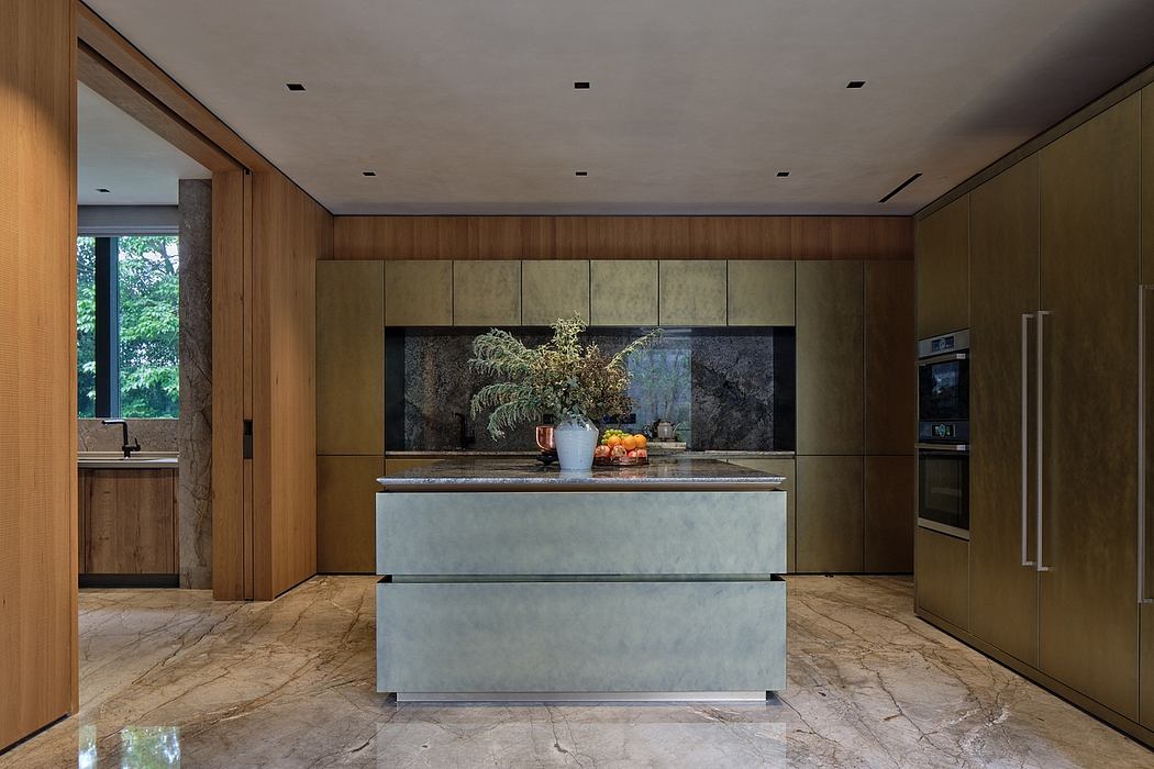 Spacious modern kitchen with sleek wood and marble design, large windows, and built-in appliances.