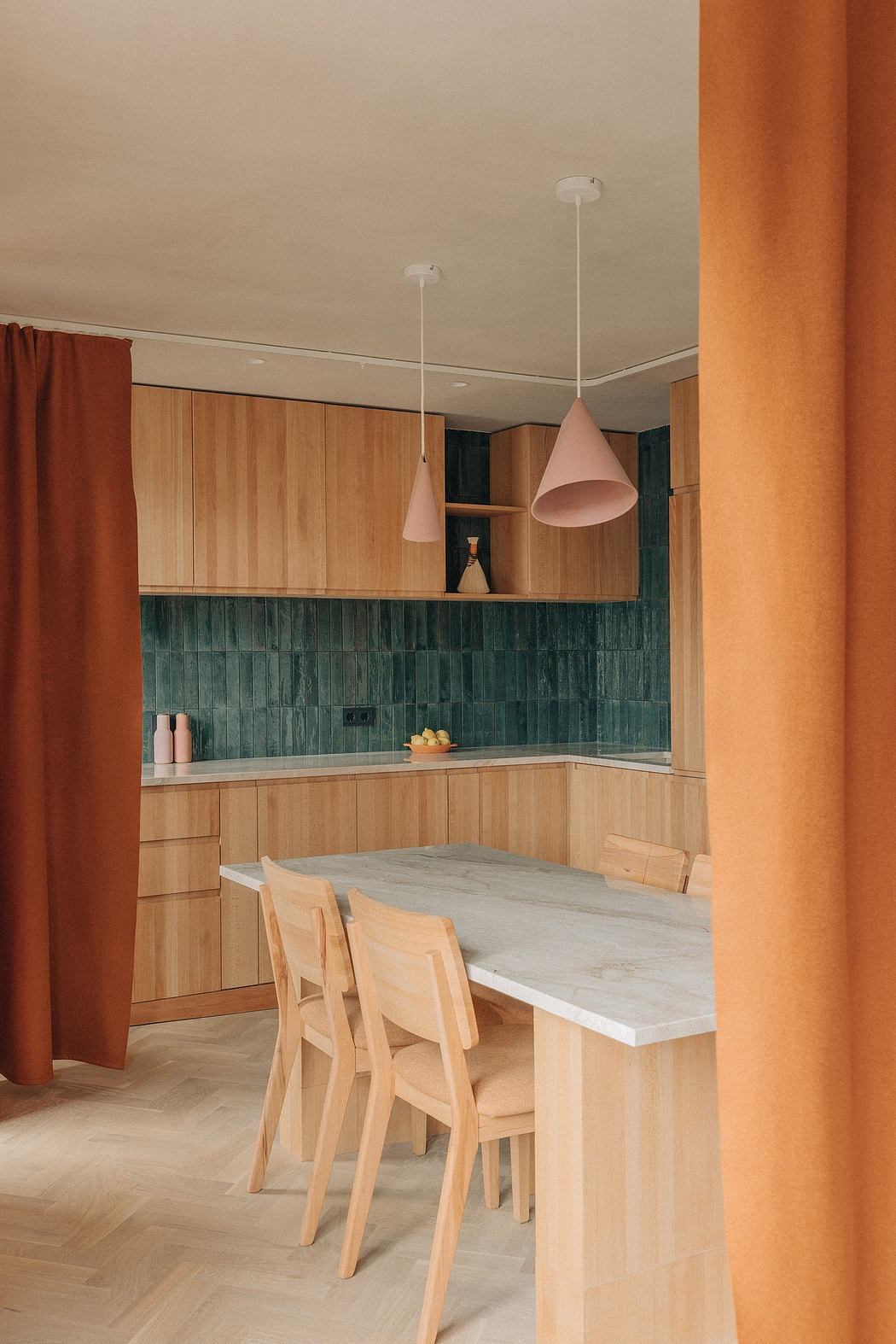 A modern kitchen with wood cabinetry, green subway tile, and pendant lighting.