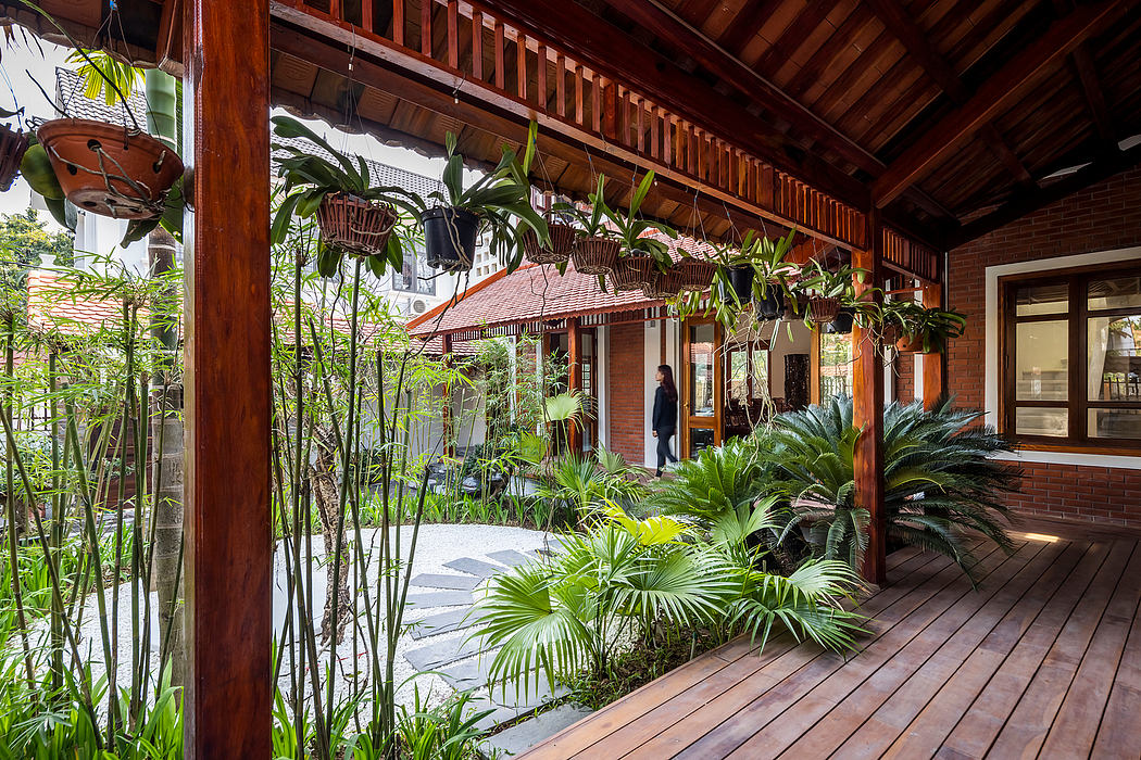 A lush, tropical interior with wooden architecture, hanging plants, and a covered walkway.