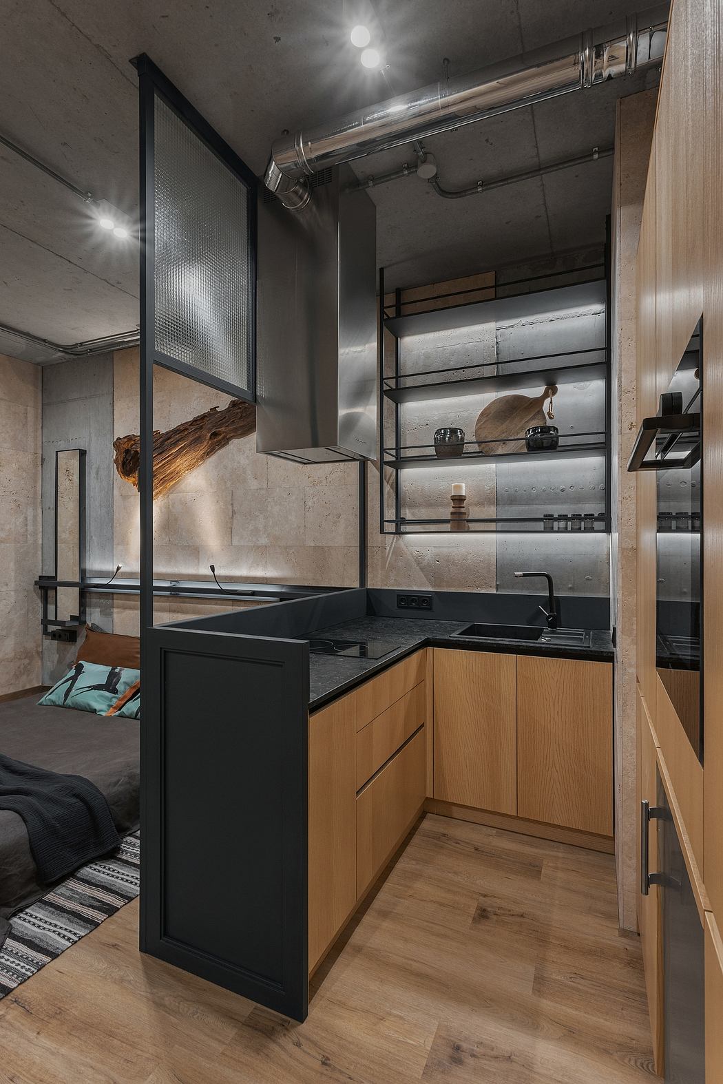 Sleek, modern kitchen with concrete walls, wood cabinetry, and black fixtures.