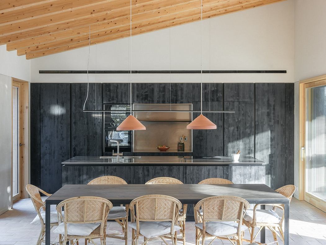 Rustic wooden ceiling beams, modern dark cabinetry, and woven rattan dining chairs.