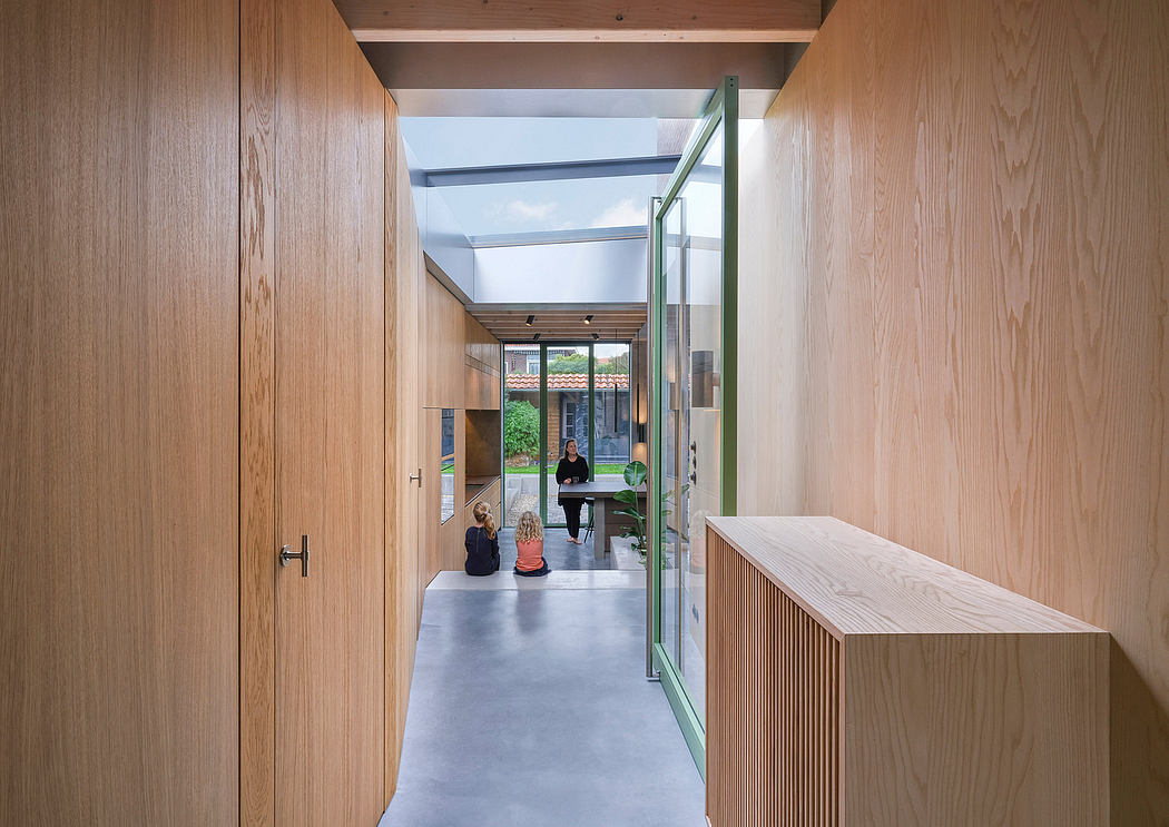 Warm wooden walls, clean concrete floors, and a bright glass entryway create a modern, inviting space.