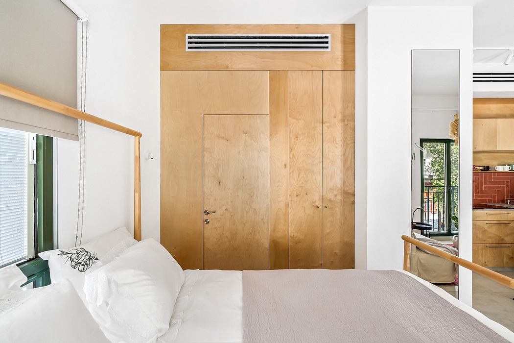 Minimalist bedroom with wooden built-in cabinetry and a modern air conditioning unit.