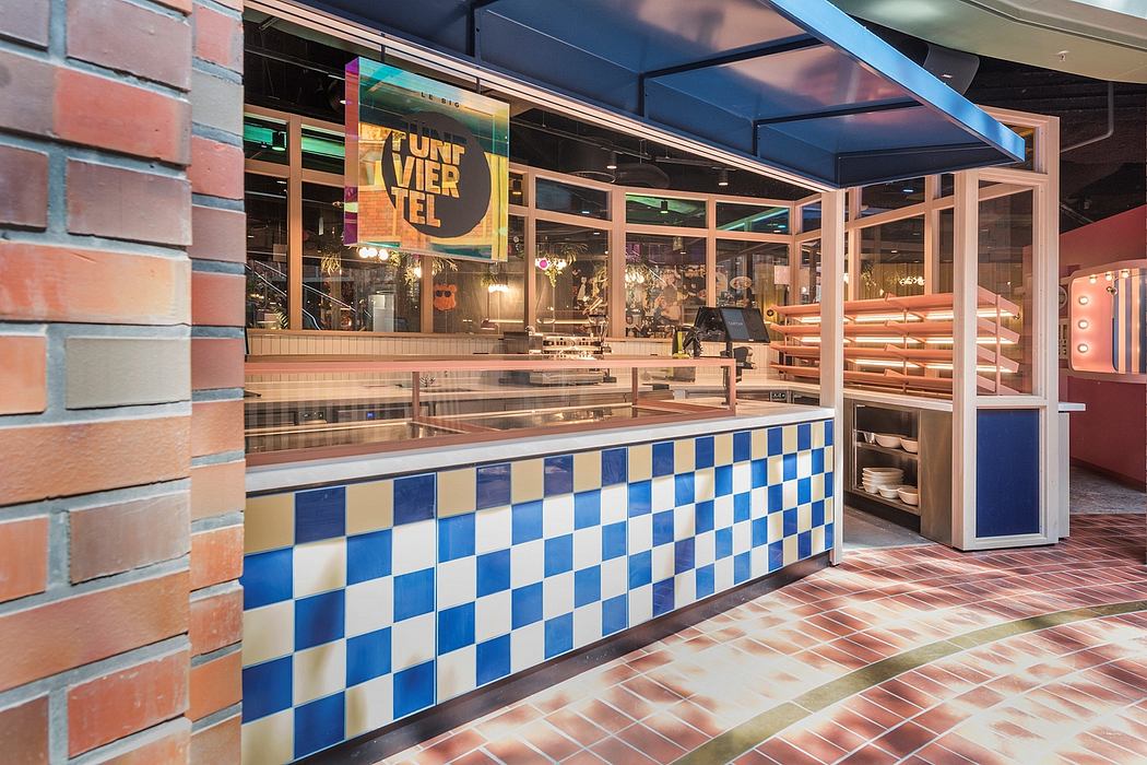 Colorful, tiled counter with bright interior design, exposed brick walls, and a large sign.