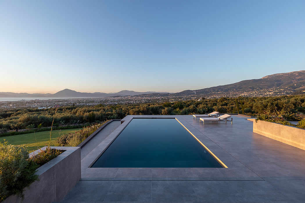 Serene infinity pool overlooking panoramic city and mountain view.