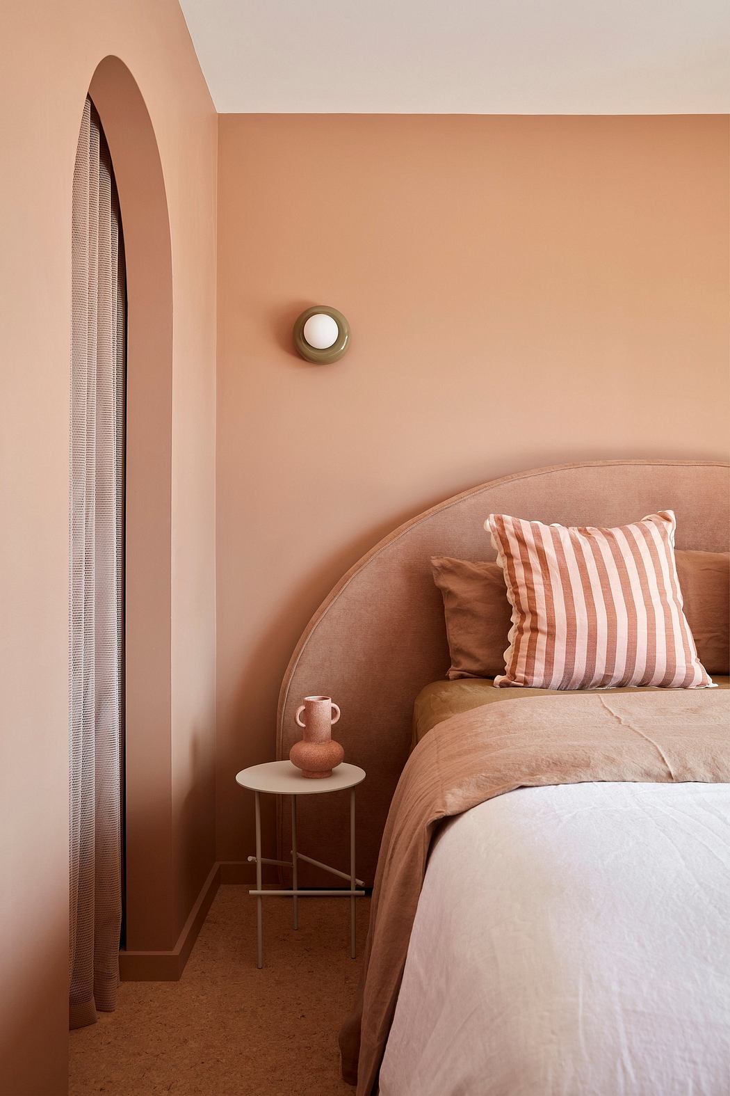 Cozy and inviting bedroom with archway, neutral tones, and modern furnishings.