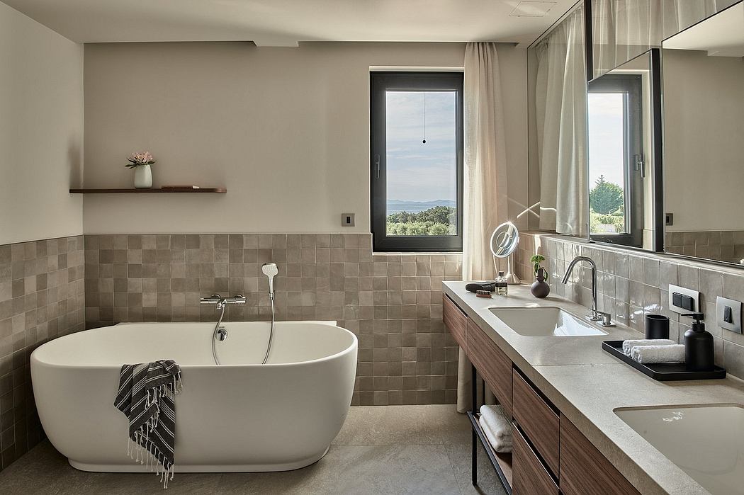 Luxurious bathroom with large tub, tiled walls, and wooden vanity overlooking scenic view.