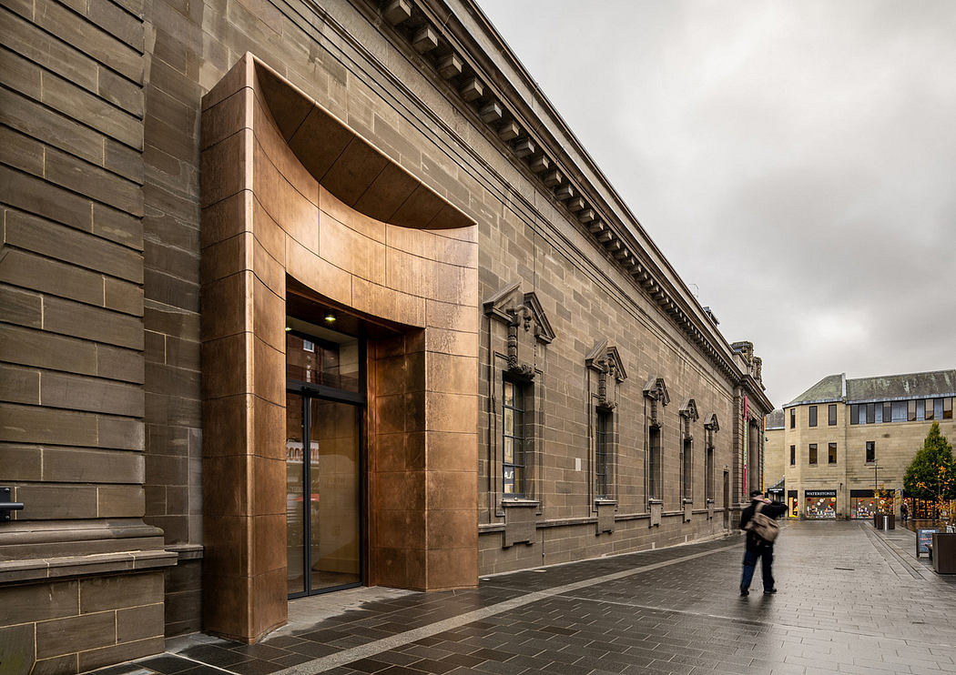 Impressive stone facade with curved archway entrance and decorative architectural details.