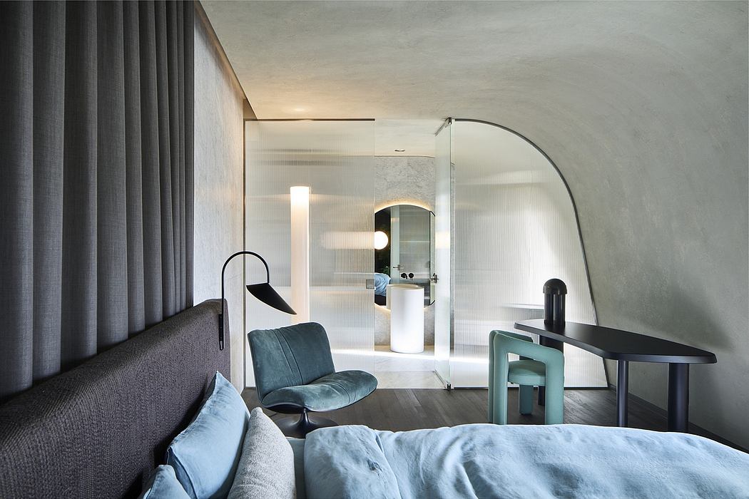 Contemporary, minimalist bedroom with gray curtains, armchair, and modern furniture.