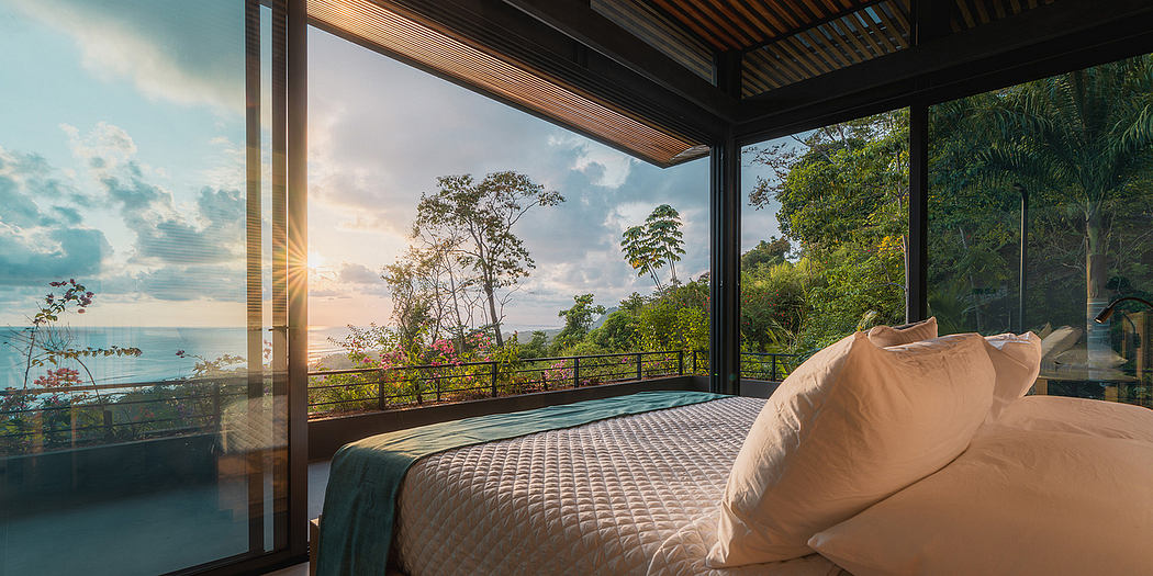 Luxurious villa bedroom with panoramic ocean view, elegant furnishings, and lush greenery.
