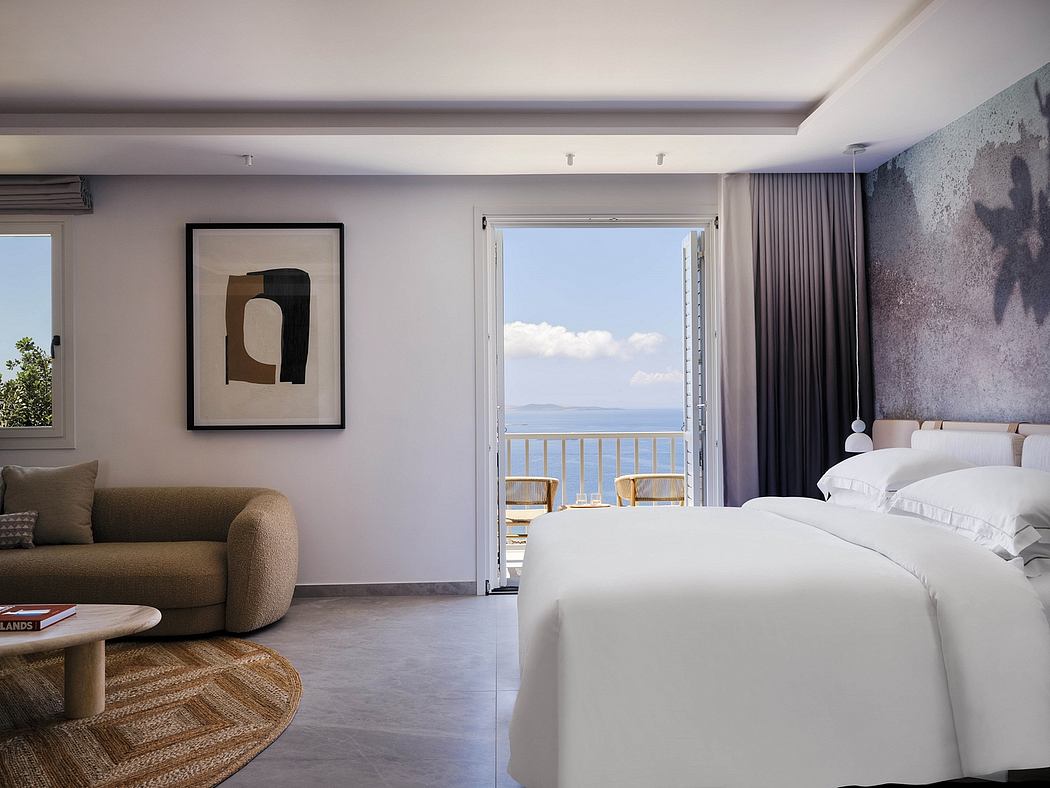Modern, minimalist hotel room with balcony overlooking scenic ocean view.