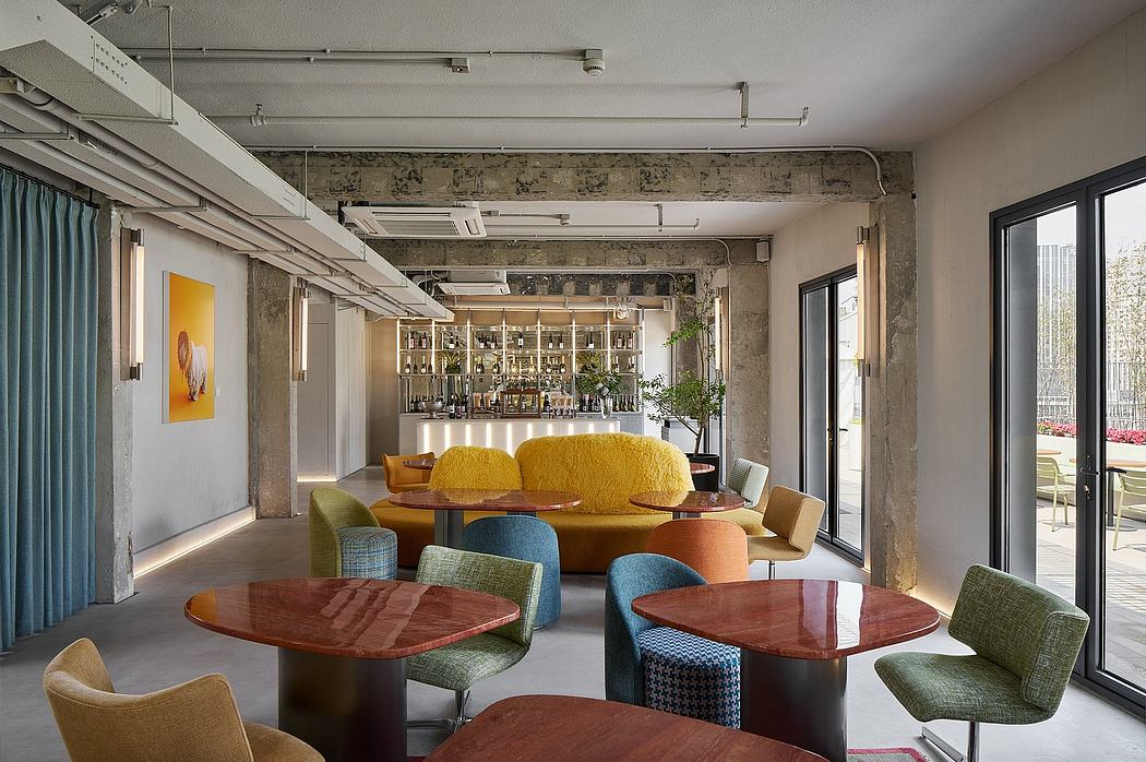 Vibrant, cozy lounge with exposed brick walls, modern furniture, and glass walls.