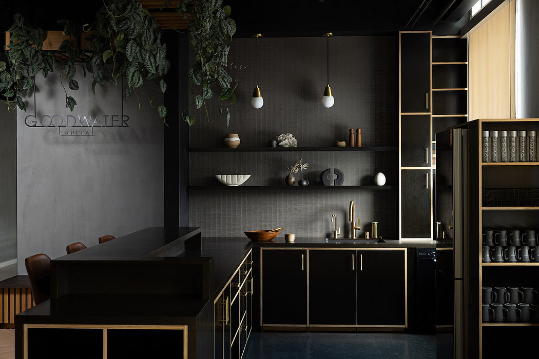 A sleek, modern kitchen design with black cabinets, brass accents, and minimalist decor.