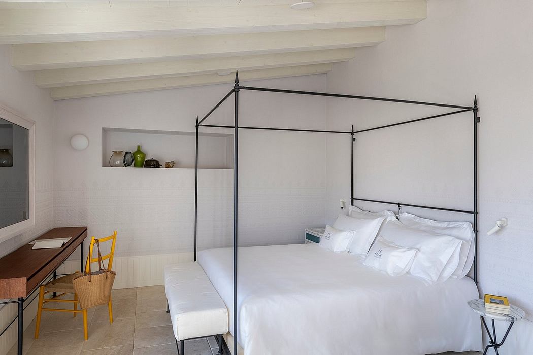 Minimalist bedroom with four-poster bed, built-in shelves, and tiled flooring.