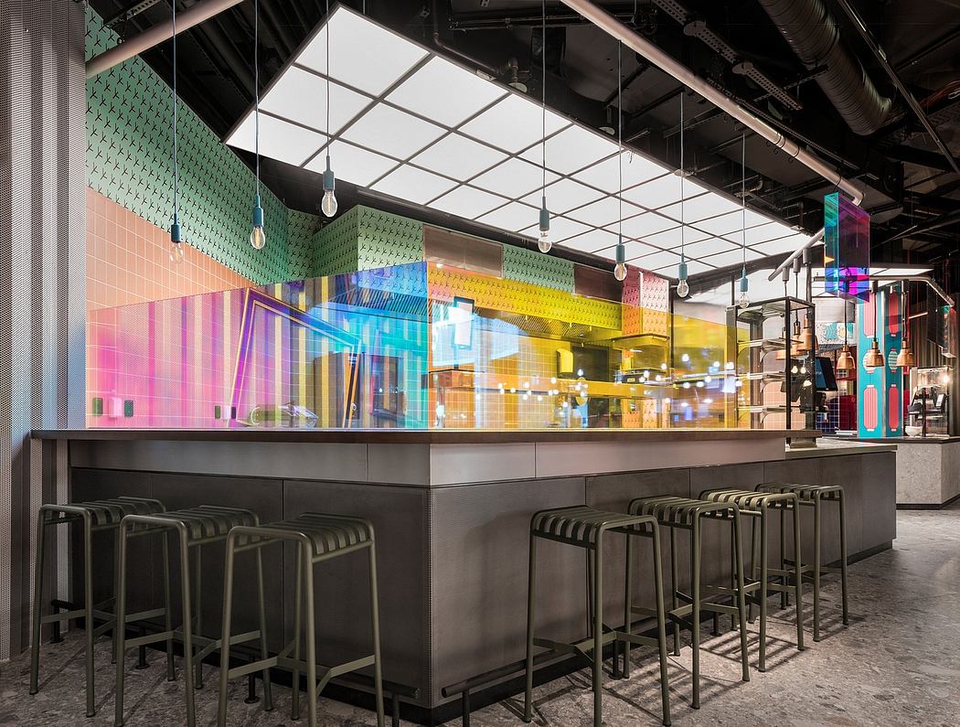 A vibrant, modern cafe interior with bold geometric patterns, colorful lighting, and sleek bar seating.