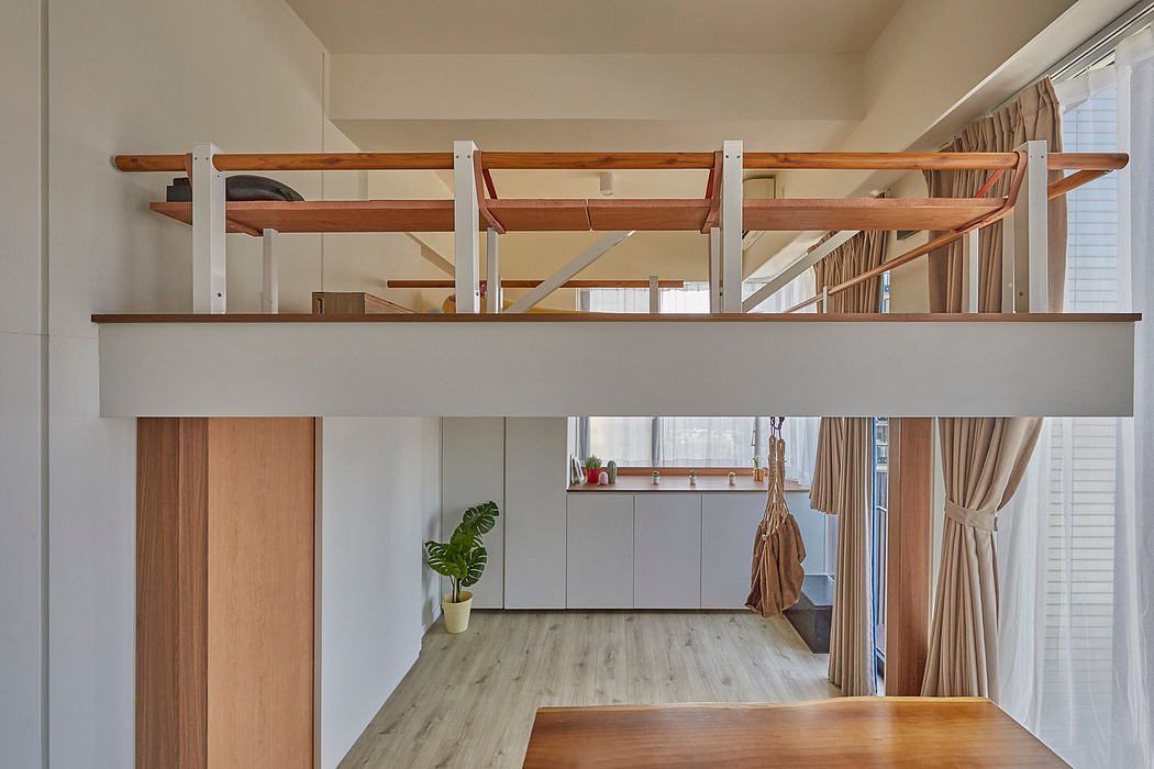 Minimalist open-plan space with wood beams, built-in cabinets, and natural light.