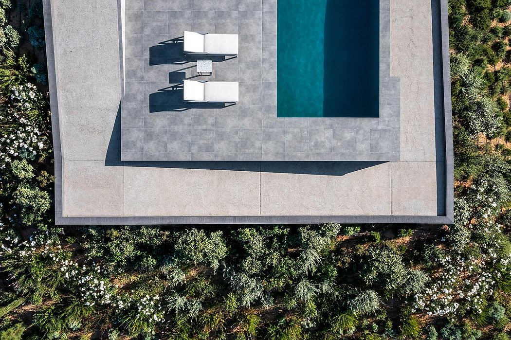 Modernist building with floating architectural elements and a vibrant, turquoise pool.