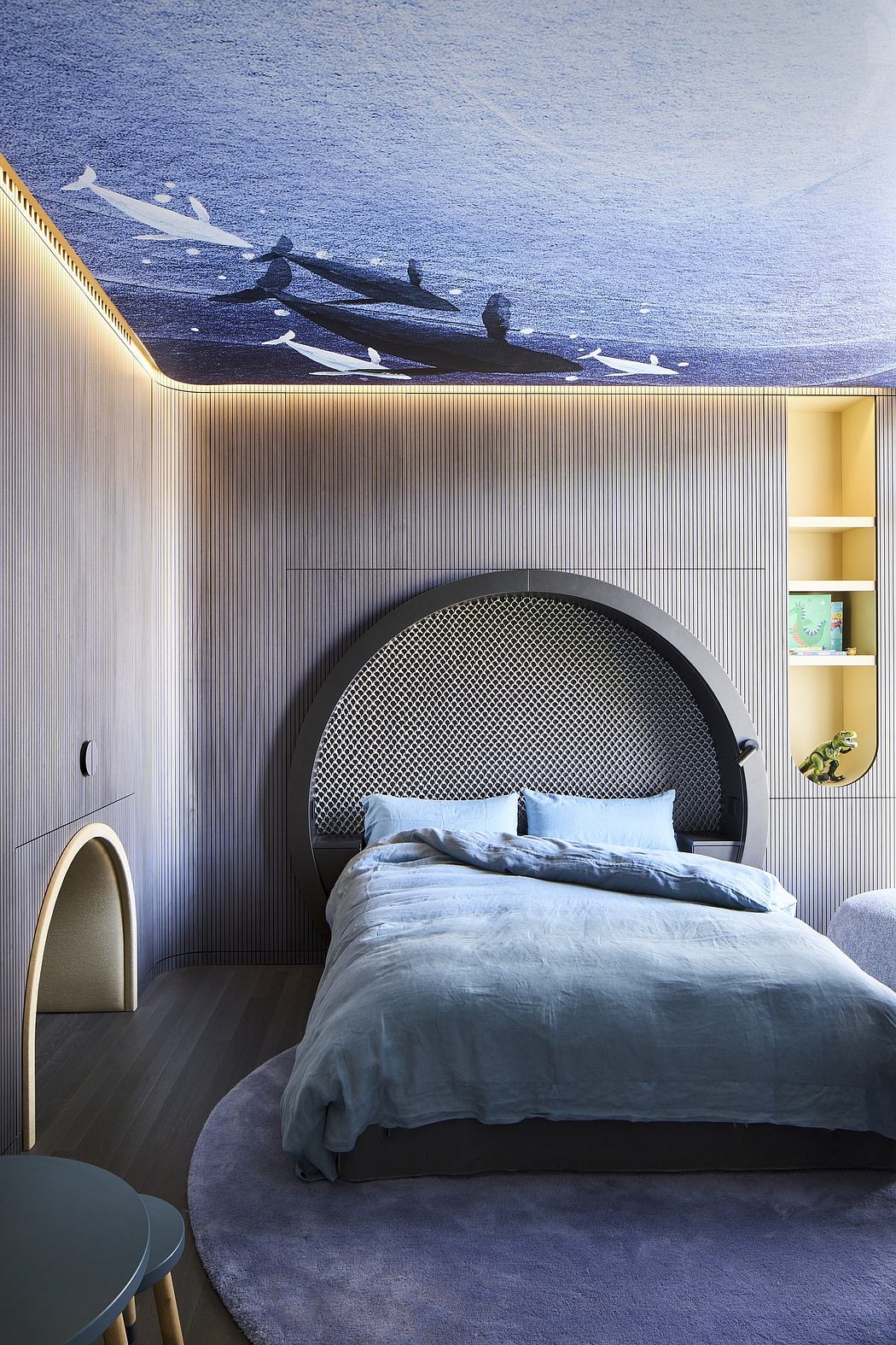 Striking modern bedroom design with curved black headboard, wood paneling, and ocean-inspired mural.