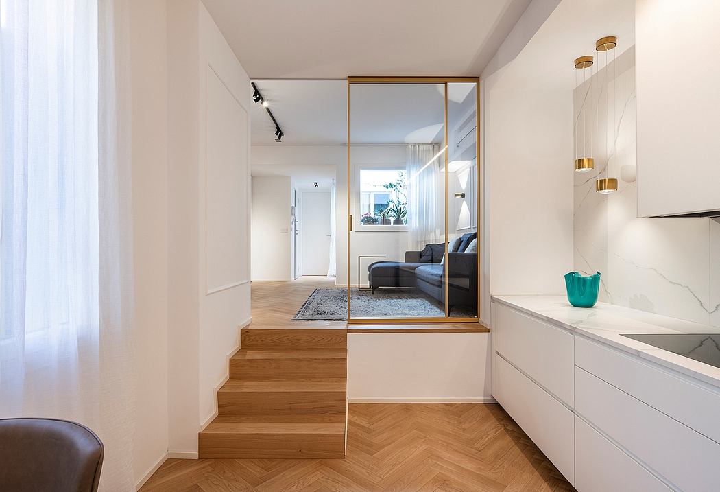 Minimalist apartment interior with wooden stairs, mirror panel, and modern decor.