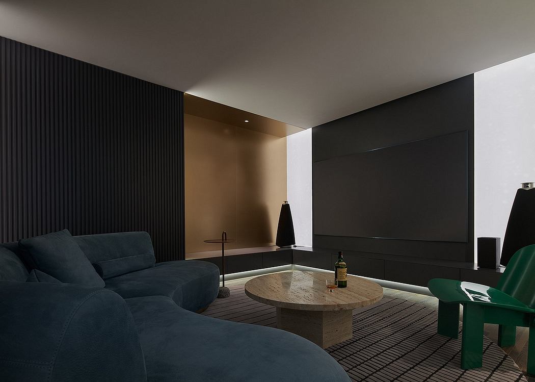 Minimalist living room with dark tones, sleek furniture, and a large TV screen.