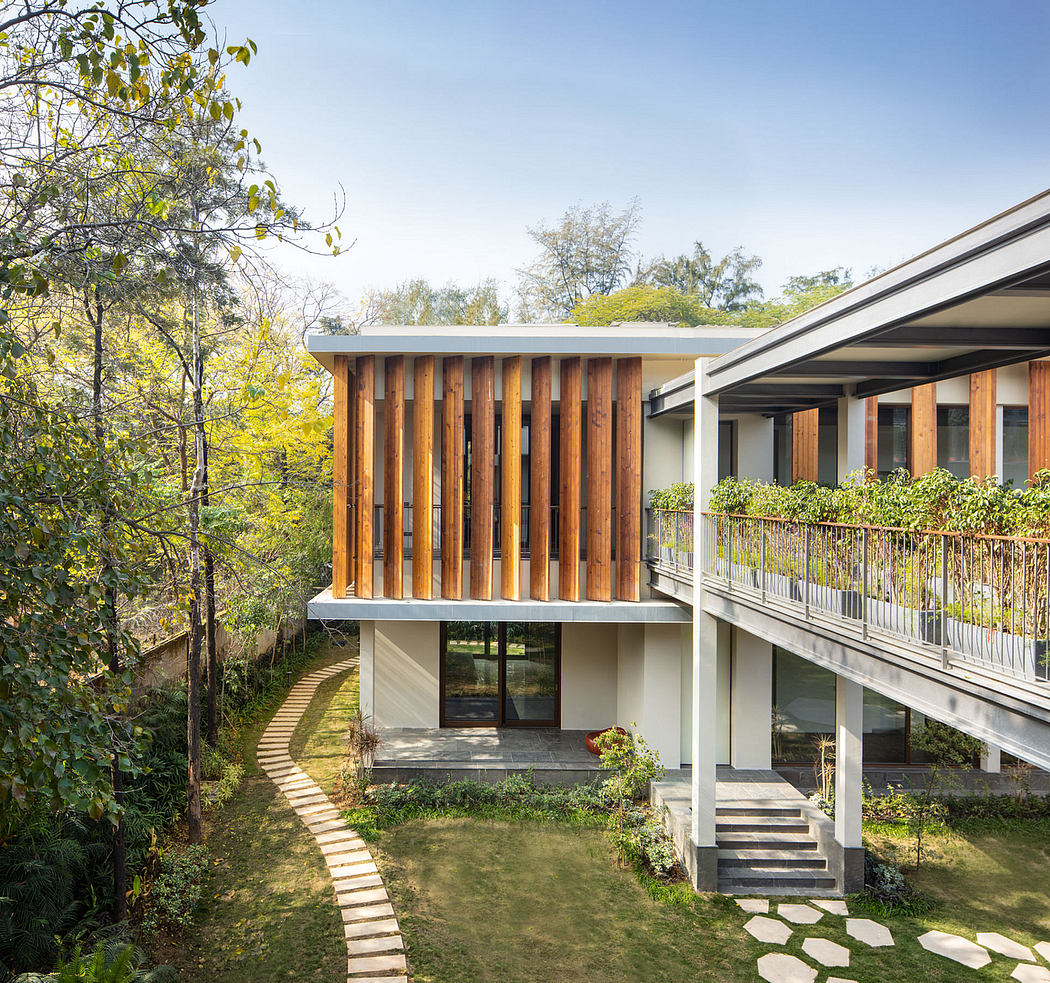 Wooden facade accents modern house design nestled in lush greenery.