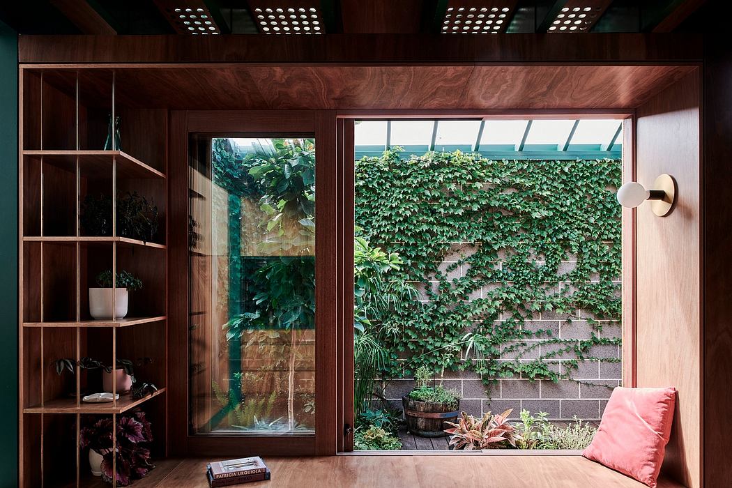 Warm, wooden interior with lush greenery visible through large windows, creating a serene ambiance.