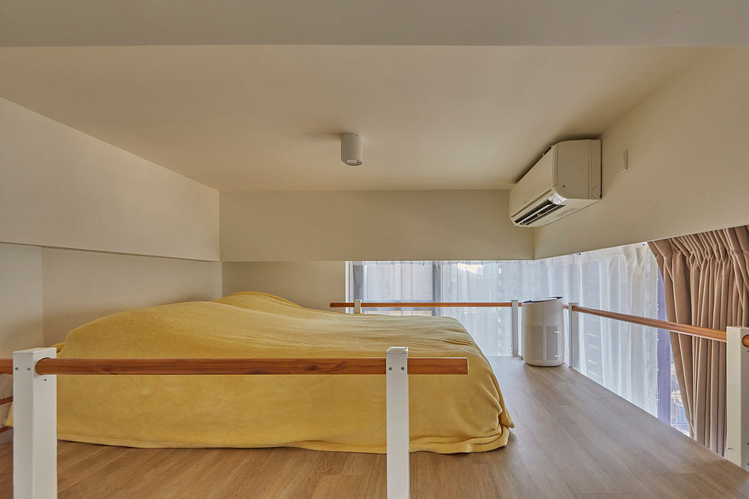 Minimalist bedroom with wooden bed frame, floor-to-ceiling windows, and air conditioning unit.