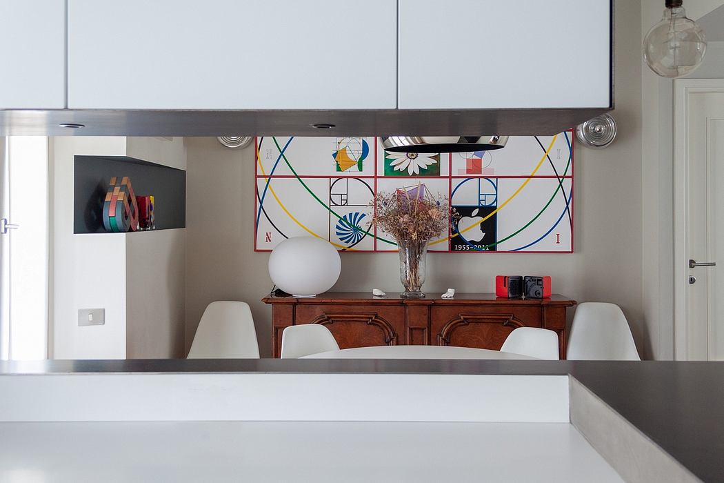 A modern, minimalist room with vibrant geometric patterned wall art and a vintage wooden sideboard.