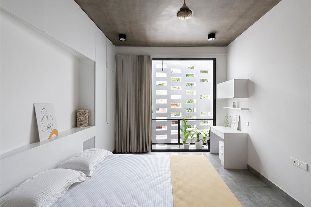 Minimalist bedroom with concrete ceiling, floor-to-ceiling curtains, and built-in storage units.